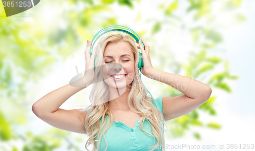 Image of happy young woman or teenage girl with headphones