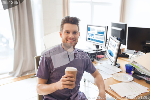 Image of happy creative male office worker drinking coffee