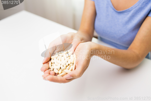 Image of close up of woman hands with medicine or pills