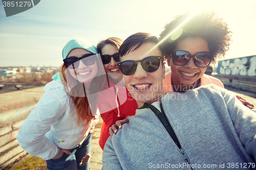 Image of group of happy friends taking selfie on street