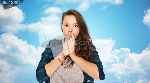 Image of scared teenage girl over blue sky