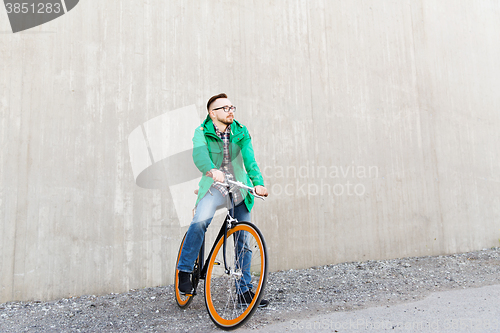 Image of happy young hipster man with fixed gear bike