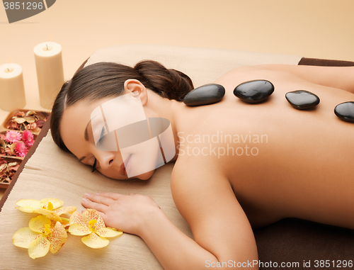 Image of beautiful woman with hot stones