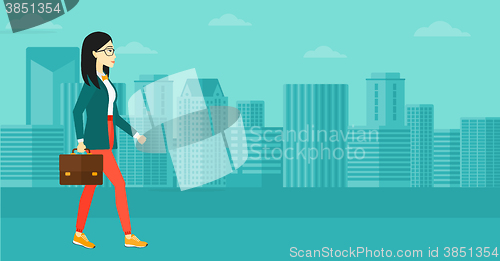 Image of Business woman walking with briefcase. 