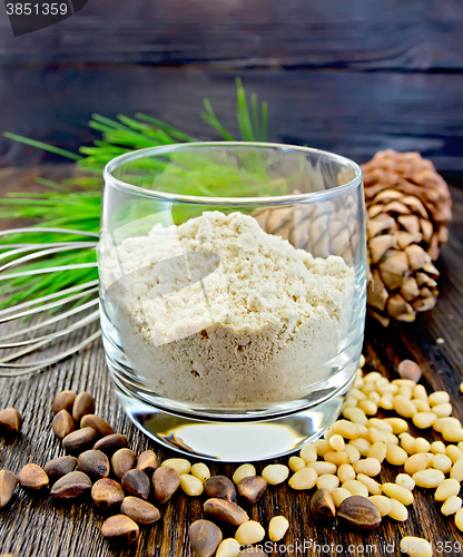 Image of Flour cedar in glass with nuts on board