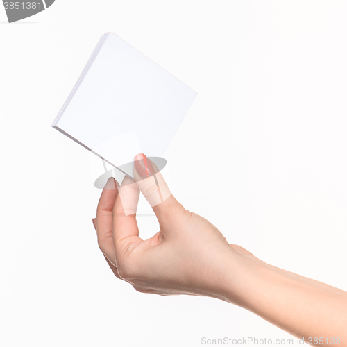 Image of Female hand holding blank paper for records on white.