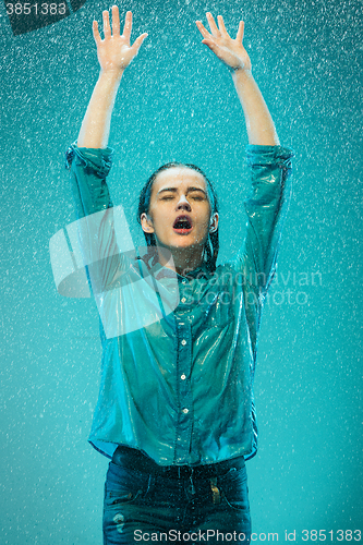 Image of The portrait of young beautiful woman in the rain