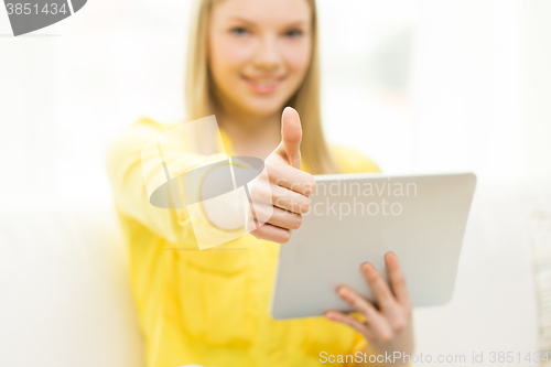 Image of close up of young woman with tablet pc at home