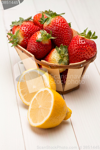 Image of Strawberries in a small basket and lemon