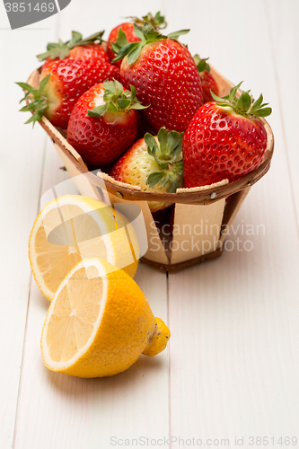 Image of Strawberries in a small basket and lemon