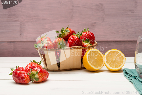 Image of Strawberries in a small basket and lemon