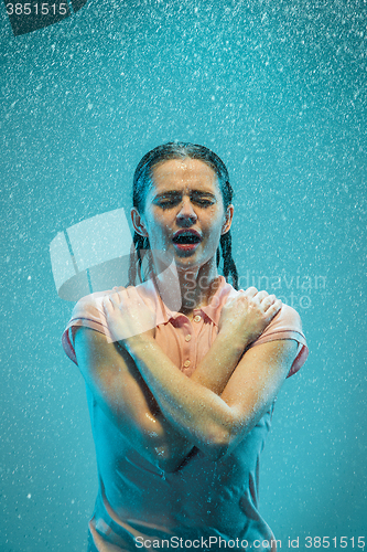 Image of The portrait of young beautiful woman in the rain