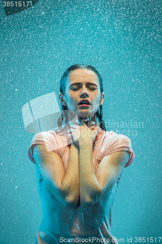 Image of The portrait of young beautiful woman in the rain