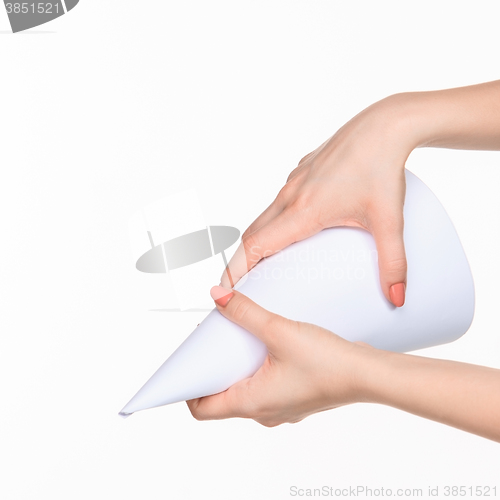 Image of The cone in female hands on white background