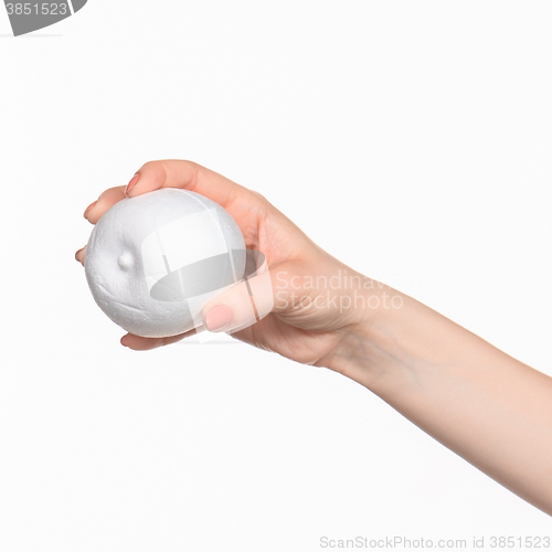 Image of The female hand holding white blank styrofoam oval 