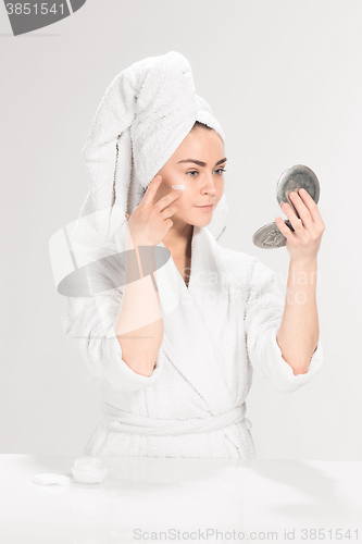 Image of Cute nice girl with cream in her face