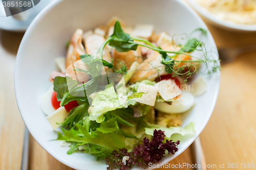 Image of close up of caesar salad on plate at restaurant