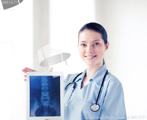 Image of female doctor with x-ray on tablet pc