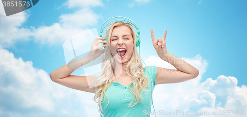 Image of happy young woman or teenage girl with headphones