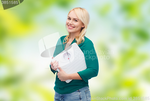 Image of smiling young woman holding scales