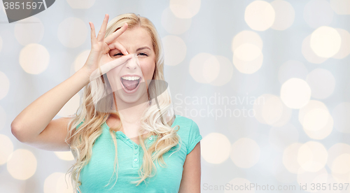 Image of young woman making ok hand gesture