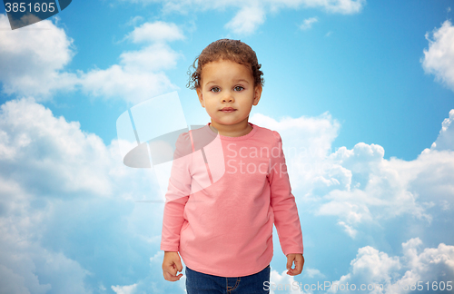 Image of beautiful little baby girl portrait over blue sky