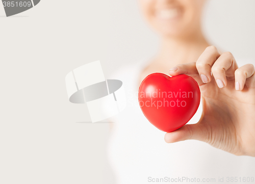 Image of happy woman with small red heart