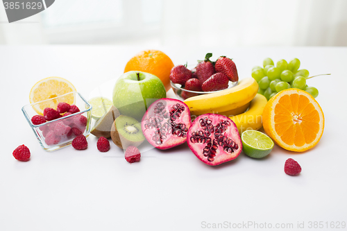Image of close up of fresh fruits and berries on table