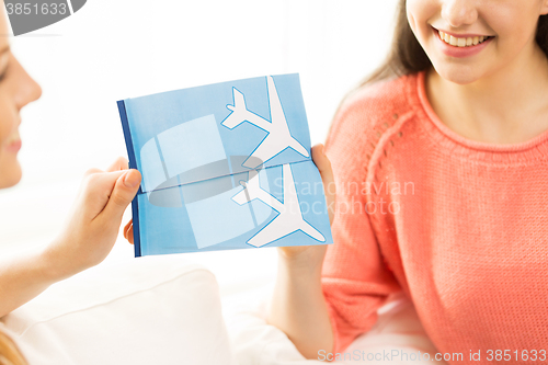 Image of close up of women with tickets and travel bag