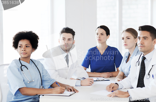 Image of group of happy doctors on conference at hospital