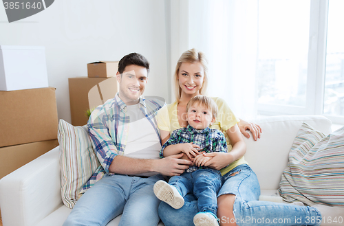 Image of happy family with boxes moving to new home