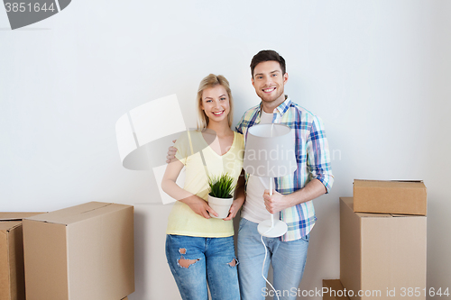 Image of happy couple with stuff moving to new home