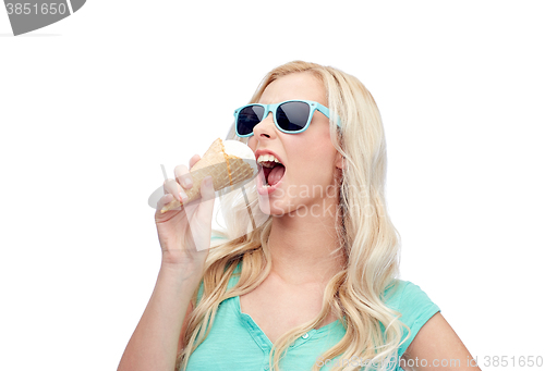 Image of happy young woman in sunglasses eating ice cream