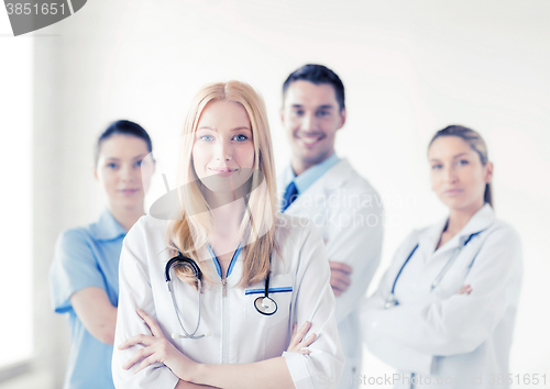 Image of female doctor in front of medical group
