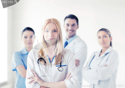 Image of female doctor in front of medical group