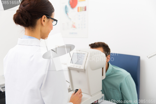 Image of optician with autorefractor and patient at clinic