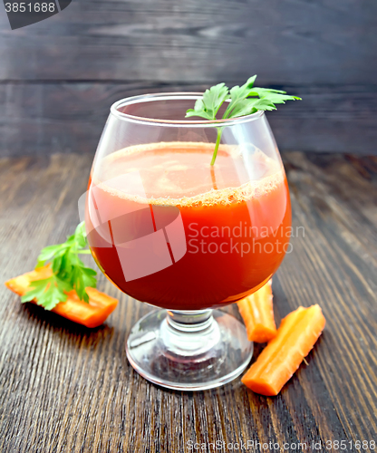 Image of Juice carrot with parsley in wineglass on board