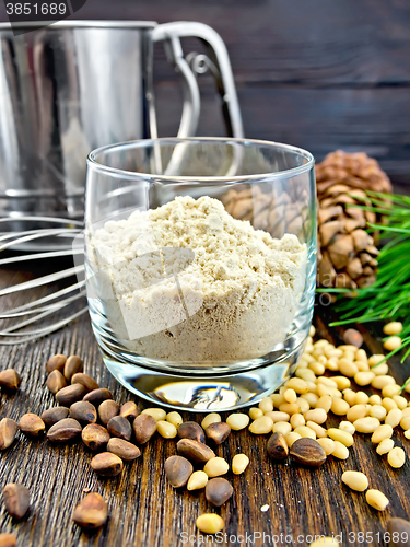 Image of Flour cedar in glass with sieve on board