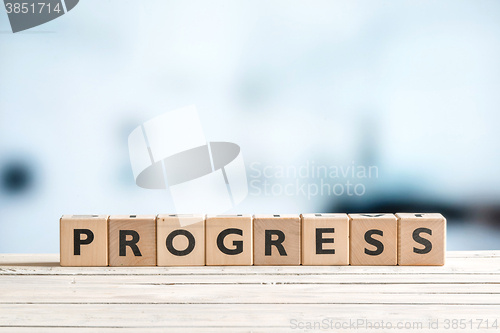 Image of Progress word spelled with wooden cubes