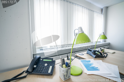 Image of Telephone and green lamps in a office