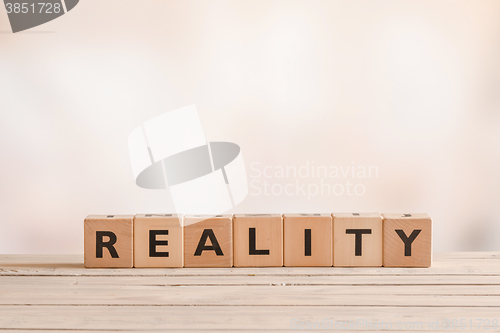 Image of Reality sign on a table of wood