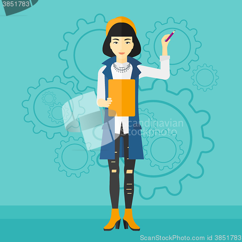 Image of Woman standing on gears background.