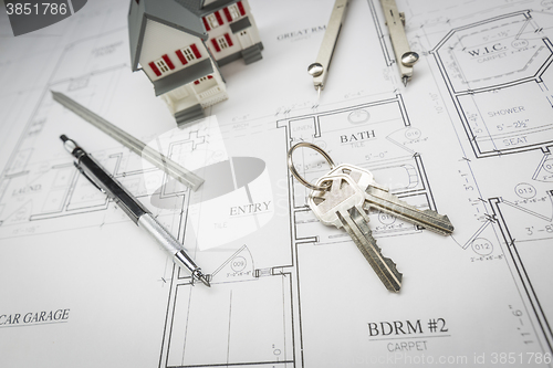 Image of Home, Pencil, Compass, Ruler and Keys Resting On House Plans