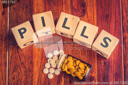 Image of The word pills on a table
