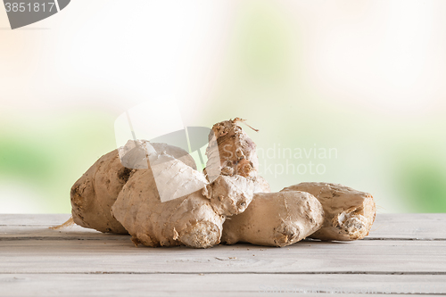 Image of Raw ginger on a wooden table