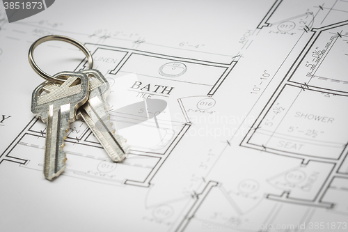 Image of Set Of New House Keys Resting On House Plans