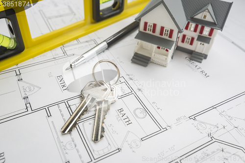 Image of Home, Construction Level, Pencil and Keys Resting on House Plans