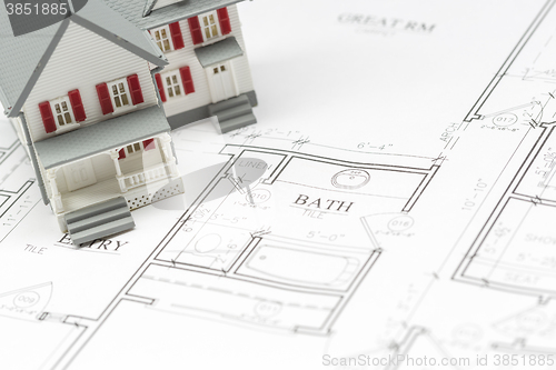 Image of Model House Resting on House Plans