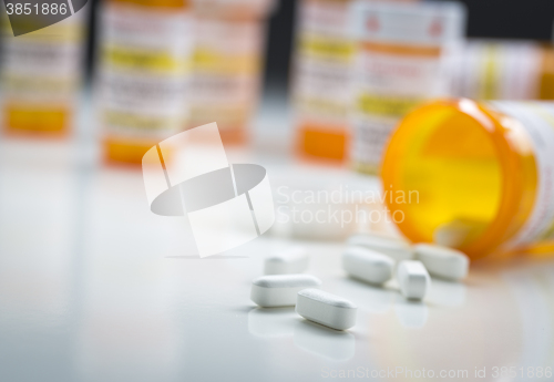 Image of Medicine Bottles Behind Pills Spilling From Fallen Bottle