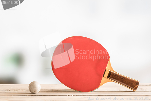 Image of Table tennis bat with a ball